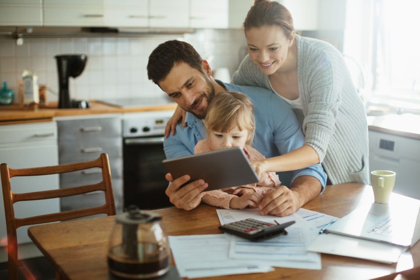 Young family using a digital tablet in the morning.