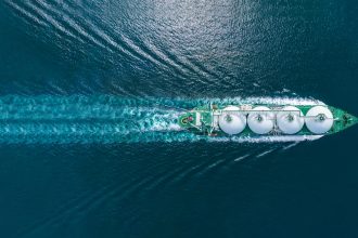 LNG (liquefied natural gas) tanker with aerial view and controller on a ocean-going vessel.